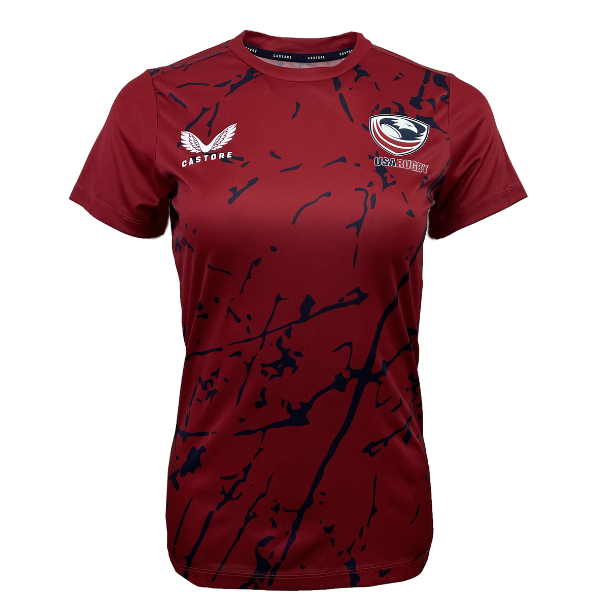 The maroon Women's USA Rugby Printed Training Tee by Castore features a navy blue splatter design, with the "Castore" logo on the left and the "USA Rugby" emblem on the right, offering style and functionality for any USA Rugby fan.