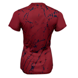 The Women's USA Rugby Printed Training Tee by Castore is a red athletic jersey featuring an abstract navy splatter pattern on the back. Its short-sleeved, fitted design is perfect for intense sessions, showcasing the excellence of USA Rugby Apparel.