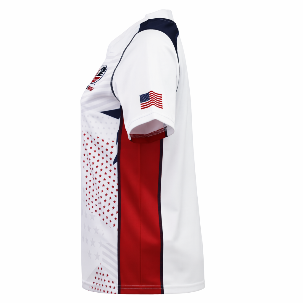 The Women's USA Rugby 22/23 RWC Home Pro Jersey by Castore features white short sleeves, red side panels, navy accents, star patterns, and an American flag patch on the left sleeve, shown from a side view.