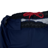 Close-up of Women's USA Rugby RWC Pro Away Shorts by Castore in blue, showcasing a black waistband with red drawstring and a handy mouth guard pocket.