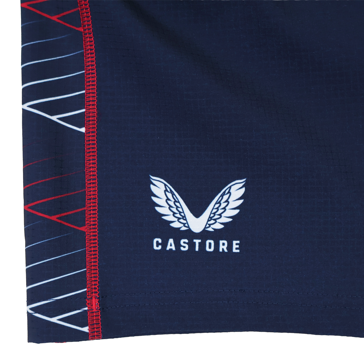 Close-up of a navy blue fabric with the Castore logo and white/red geometric lines, from the Women's USA Rugby 22/23 7s RWC Away Pro Short by Castore.