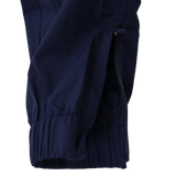Close-up of a navy blue jacket sleeve with a zipper and elastic cuff, ideal for pairing with Castore’s Womens USA Rugby Weather-resistant Pant, against a plain background.