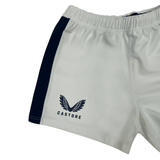 White women's athletic shorts by Castore, featuring a dark blue side stripe, emblem, and the word "Castore" on one leg. Ideal for rugby enthusiasts seeking style and performance in the USA Rugby Pro Away Shorts.
