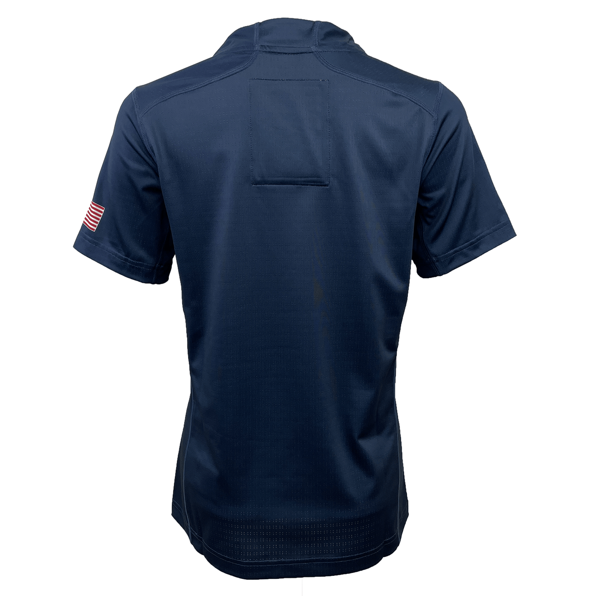 The Women's USA Rugby Training Jersey by Castore, in navy blue, features a back view with short sleeves and an American flag patch on the right sleeve. It's crafted from moisture-wicking fabric ideal for intense rugby training.