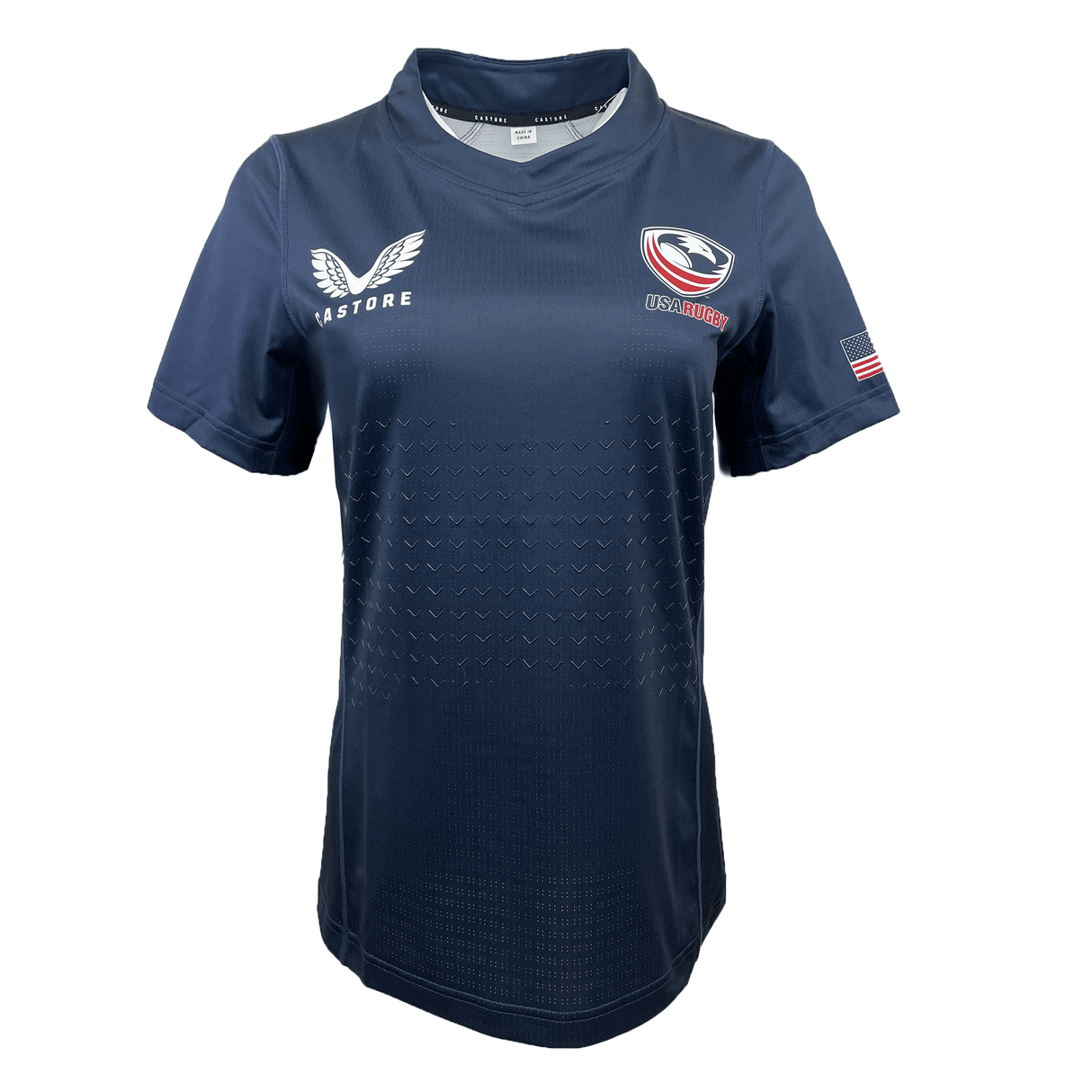 The Women's USA Rugby Training Jersey by Castore, in navy blue, features a "USA" logo, white bird emblem, and American flag on the sleeve. Made with moisture-wicking fabric for an athletic fit, it provides ultimate comfort and performance.
