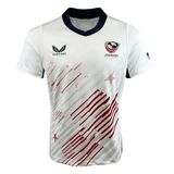 The Women's USA Rugby Pro Away Jersey by Castore is an athletically tailored white jersey with red and blue accents, featuring USA Rugby and Castore logos. It boasts an abstract red stripe pattern on moisture-wicking fabric for ultimate comfort.
