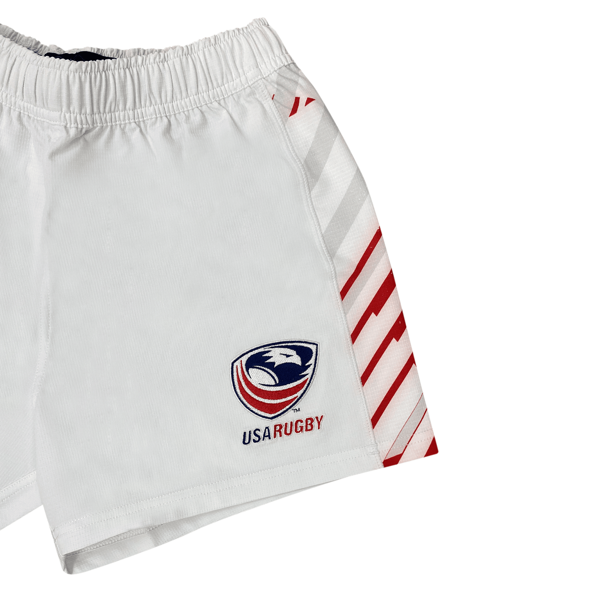 Women's USA Rugby Pro Away Shorts by Castore: White rugby shorts with red and white diagonal stripes on one side and the USA Rugby logo on the left leg.