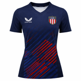 The Women's USA Rugby 24/25 7s Olympic Pro Home Jersey by Castore features navy blue fabric with red diagonal stripes, a Castore logo on the right chest, and a USA shield badge on the left chest.
