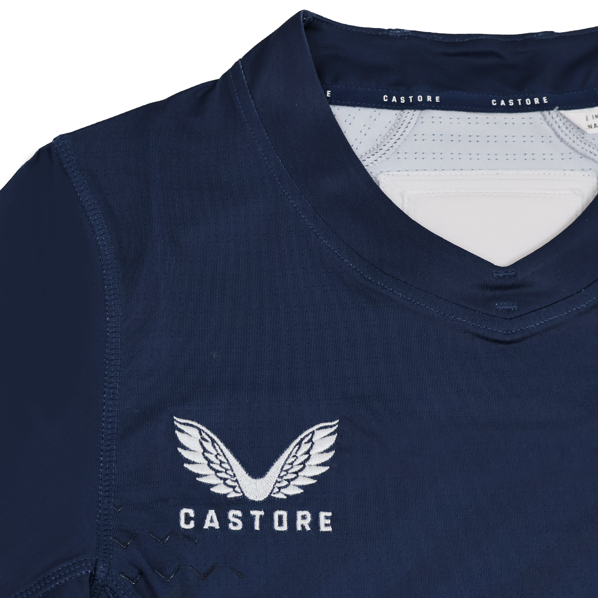 Close-up of the Women's USA Rugby 24/25 7s Olympic Pro Home Jersey by Castore, in navy blue, featuring the white embroidered Castore logo with wings above the "CASTORE" text.
