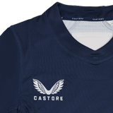 Close-up of the Women's USA Rugby 24/25 7s Olympic Pro Home Jersey by Castore, in navy blue, featuring the white embroidered Castore logo with wings above the "CASTORE" text.