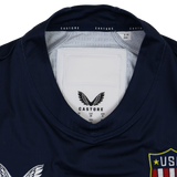 Close-up of the collar and label on the Women's USA Rugby 24/25 7s Olympic Pro Home Jersey by Castore, showing the brand logo, sizing details, and part of the team crest.