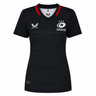 The Women's Saracens Home Replica Jersey 24/25 by Castore features a black design with subtle checks, red collar accents, and white Castore and Saracens logos—ideal for rugby fans.