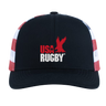 The USA Rugby Throwback Flag Cap by EMB Augusta is a black cap featuring "USA Rugby" and a red eagle logo on the front, plus bold red and white side stripes for a classic rugby look.