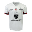 The Stade Toulousain Replica Away Jersey by Nike is a white jersey that showcases logos for Airbus, Rempart Mutuelle, and Peugeot. It features the iconic red and black emblem with intertwined letters.