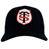 Front view of a black Stade Toulousain Classic 99 Trucker Cap by Nike featuring an embroidered ST crest with intertwined "S" and "T" letters in white and red, bordered by a red and white shield design.