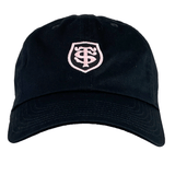 A Stade Toulousain Heritage 86 Cap by Nike is a black and pink adjustable hat with a light pink shield emblem embroidered on the front.