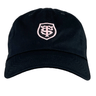 A Stade Toulousain Heritage 86 Cap by Nike is a black and pink adjustable hat with a light pink shield emblem embroidered on the front.