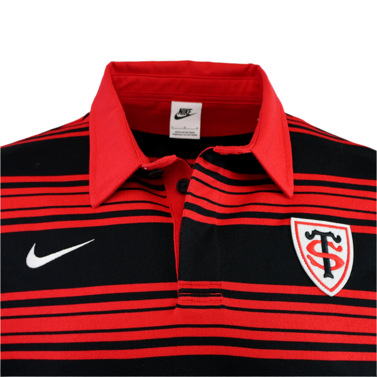 The Stade Toulousain 25/26 Heritage Long Sleeve Rugby Jersey by Nike features black and red stripes, a Nike logo, and a shield-shaped "ST" badge on the chest.