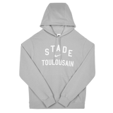 The Stade Toulousain 25/26 Premium Pullover Hoodie by Nike is a light gray hoodie with "STADE TOULOUSAIN" in white on the front and a drawstring hood for comfort.