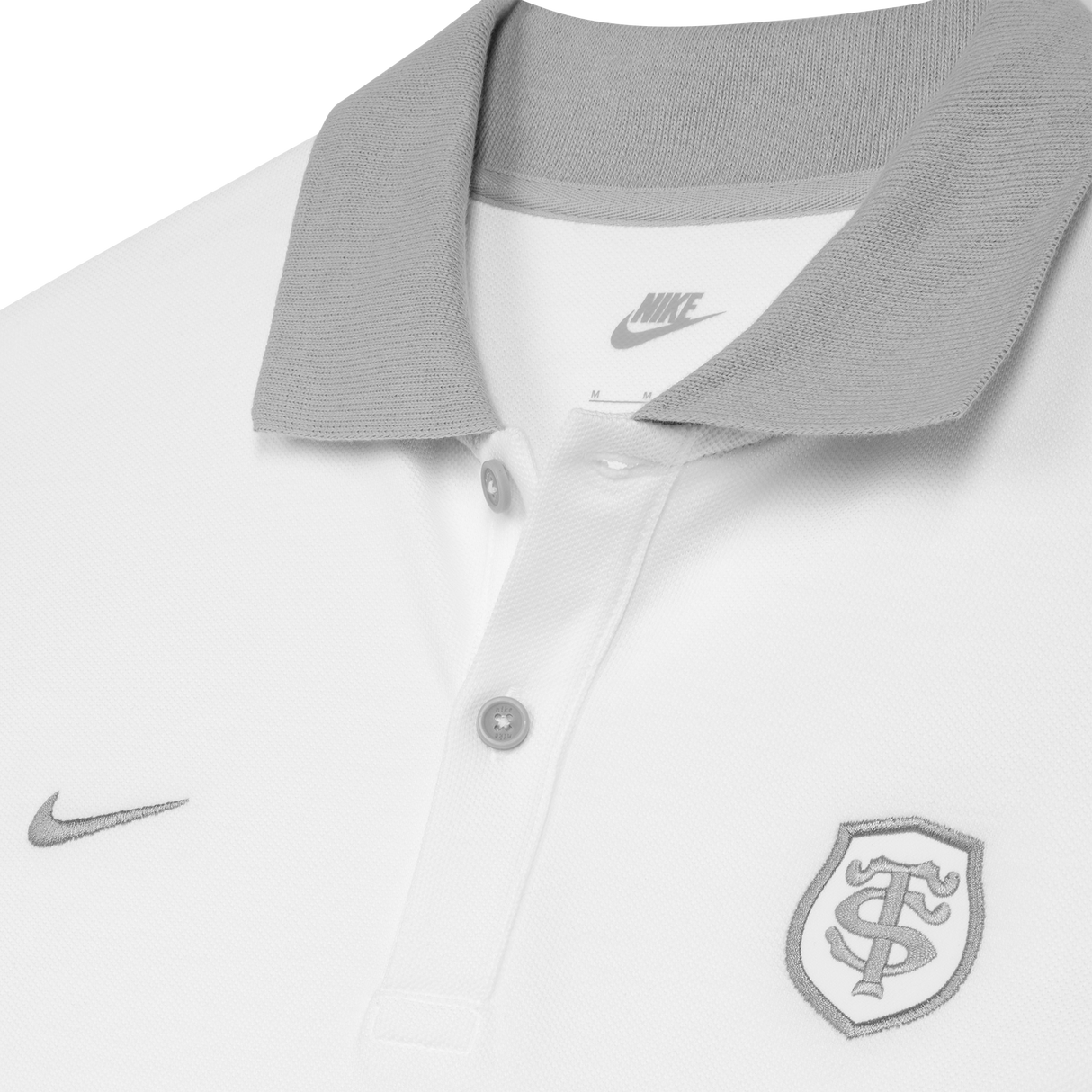 Close-up of the Stade Toulousain 25/26 Premium Pique Polo by Nike: a white collared rugby polo with gray buttons, gray collar, and two embroidered logos on the chest.