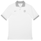The Nike Stade Toulousain 25/26 Premium Pique Polo is a white short-sleeve shirt with a grey collar and sleeve trim, featuring a small grey Nike logo and the Stade Toulousain crest on the left chest.