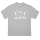 The Nike Stade Toulousain 25/26 Premium Loose-Fit T-Shirt is a grey cotton tee with "STADE TOULOUSAIN" boldly printed in white on the front.