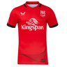 The Ulster 24/25 Replica Away Jersey by Castore is an athletic fit, red sports jersey displaying the Ulster Rugby logo and "Kingspan" branding in white text. It includes a black collar and sleeve trim to create a striking contrast.