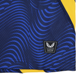 Close-up of the Leinster 25/26 Third Pro Shirt by Castore, featuring dark blue and yellow colors, wavy blue patterns, and an "Authentic Castore Product" label with a winged logo.