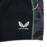 Close-up of the Harlequins 22/23 3rd Pro Short by Castore, showcasing black fabric with the white wings logo and green seam stitching, inspired by classic rugby style.