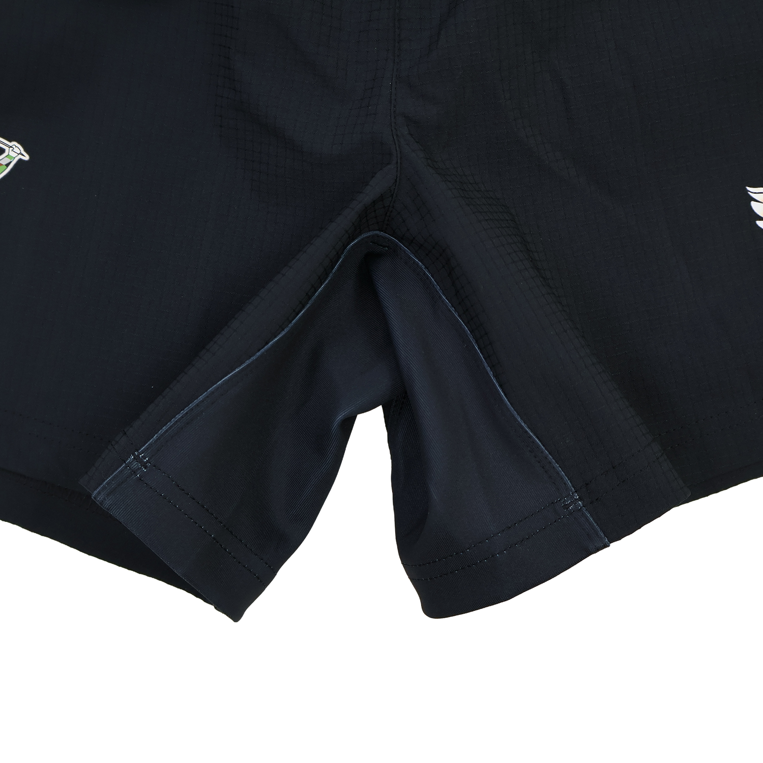 Close-up of the crotch area on the black Harlequins 22/23 3rd Pro Short by Castore, showing visible seams and small embroidered logos on each leg.