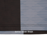 Close-up of fabric from the Harlequins Replica Home Jersey 22/23 by Castore, showing a dark and light geometric design with "Better Never Stops" printed near a seam.