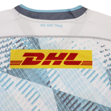 Back of the Harlequins Replica Away Jersey 22/23 by Castore, featuring a yellow DHL logo, "WE ARE TRUE" near the collar, and a blue and white geometric pattern inspired by Castore’s design.