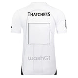 Back view of the Bath Rugby 25/26 Away Jersey by Castore in white, featuring "THATCHERS" at the top, a blank square in the center, and "washG1" near the bottom—official away jersey.