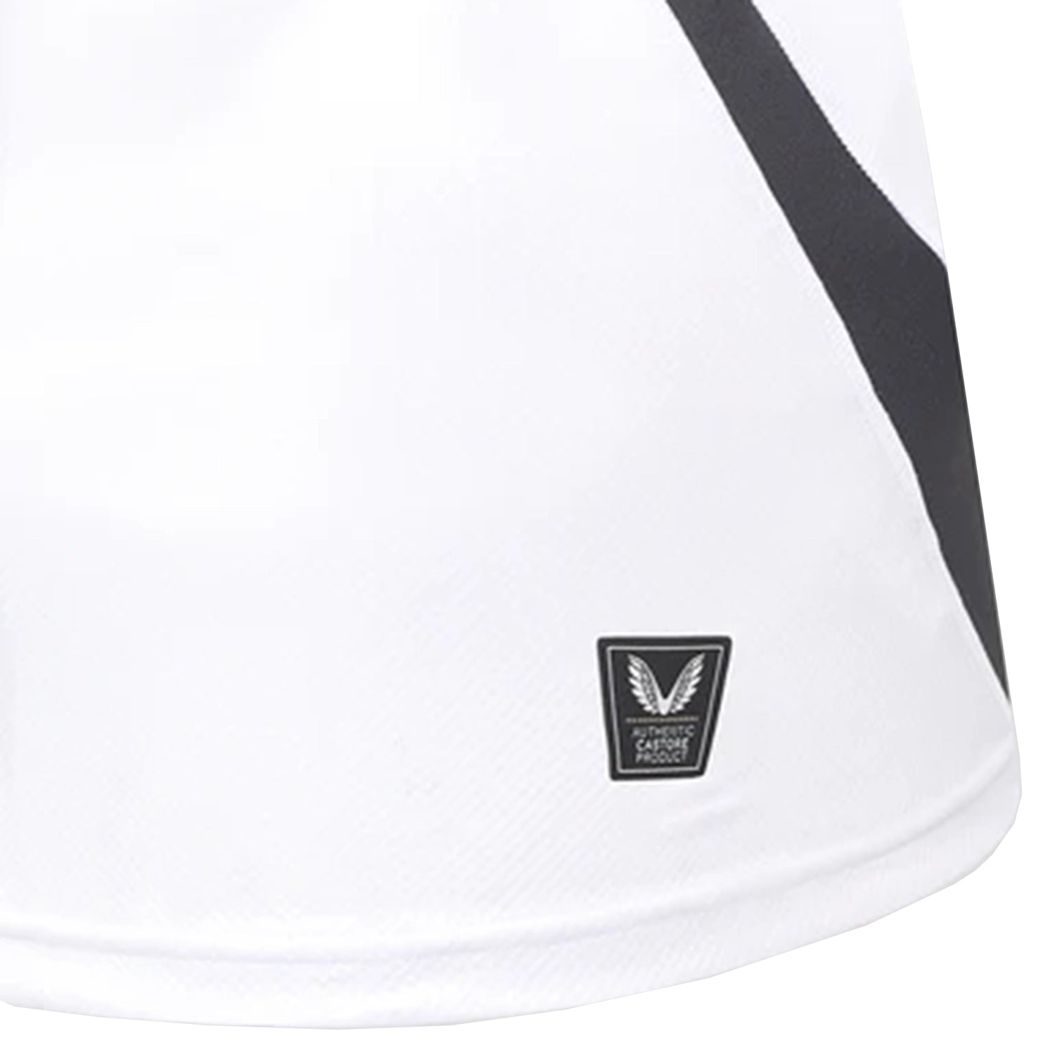 Close-up of the Bath Rugby 25/26 Away Jersey by Castore, showing a black diagonal stripe and a small rectangular authenticity label near the hem.