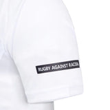 A close-up of the Bath Rugby 25/26 Away Jersey by Castore sleeve, featuring a "RUGBY AGAINST RACISM" black patch and highlighting the team's partnership with Castore.