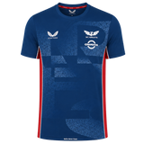 The Scarlets Training Tee 22/23 by Castore features blue short sleeves, an athletic fit, geometric patterns, white sponsor and team logos on the chest, and bold red side panels.