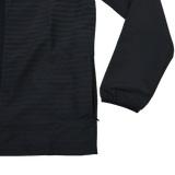 A close-up of the lower section of the Ulster 25/26 Woven Pre Match Jacket by Castore, in black, featuring a zipper and elastic cuff, shown against a plain white background.