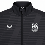 The Ulster 25/26 Woven Pre Match Jacket by Castore features black and grey design, full zip, high collar, Castore logo on the left, and Ulster Rugby emblem on the right.