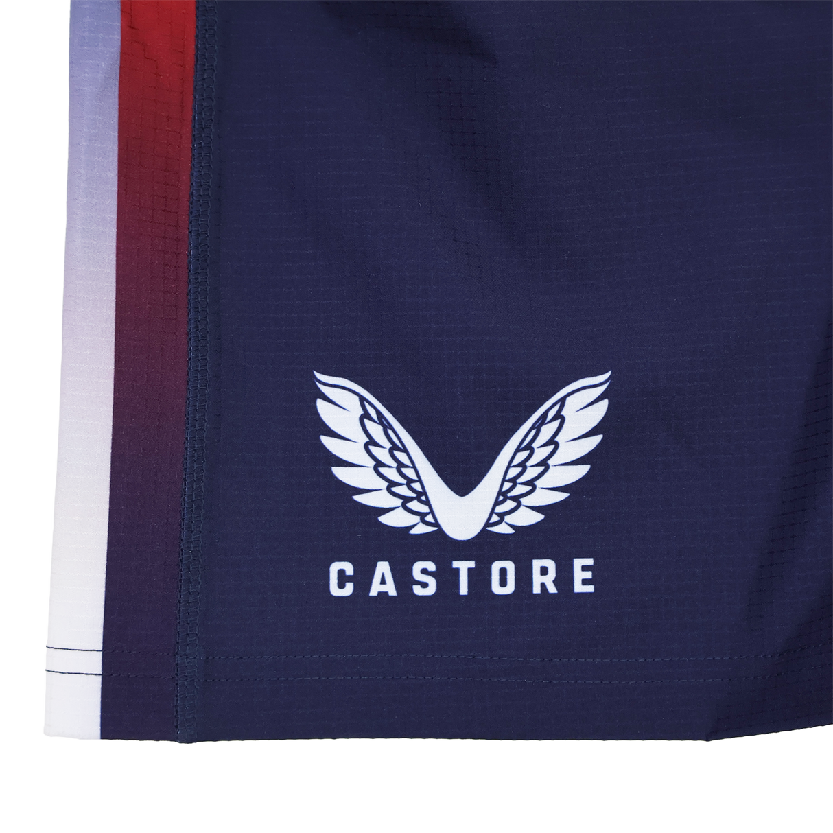 Close-up of Castore USA Rugby Pro Home Short 22/23, featuring the white wings Castore logo and brand name, plus a vertical red and white stripe on the left edge.