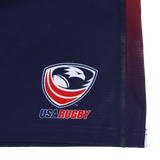 Close-up of a navy blue fabric with the USA Rugby logo and "USA RUGBY" text, featured on the official USA Rugby Pro Home Short 22/23 by Castore.
