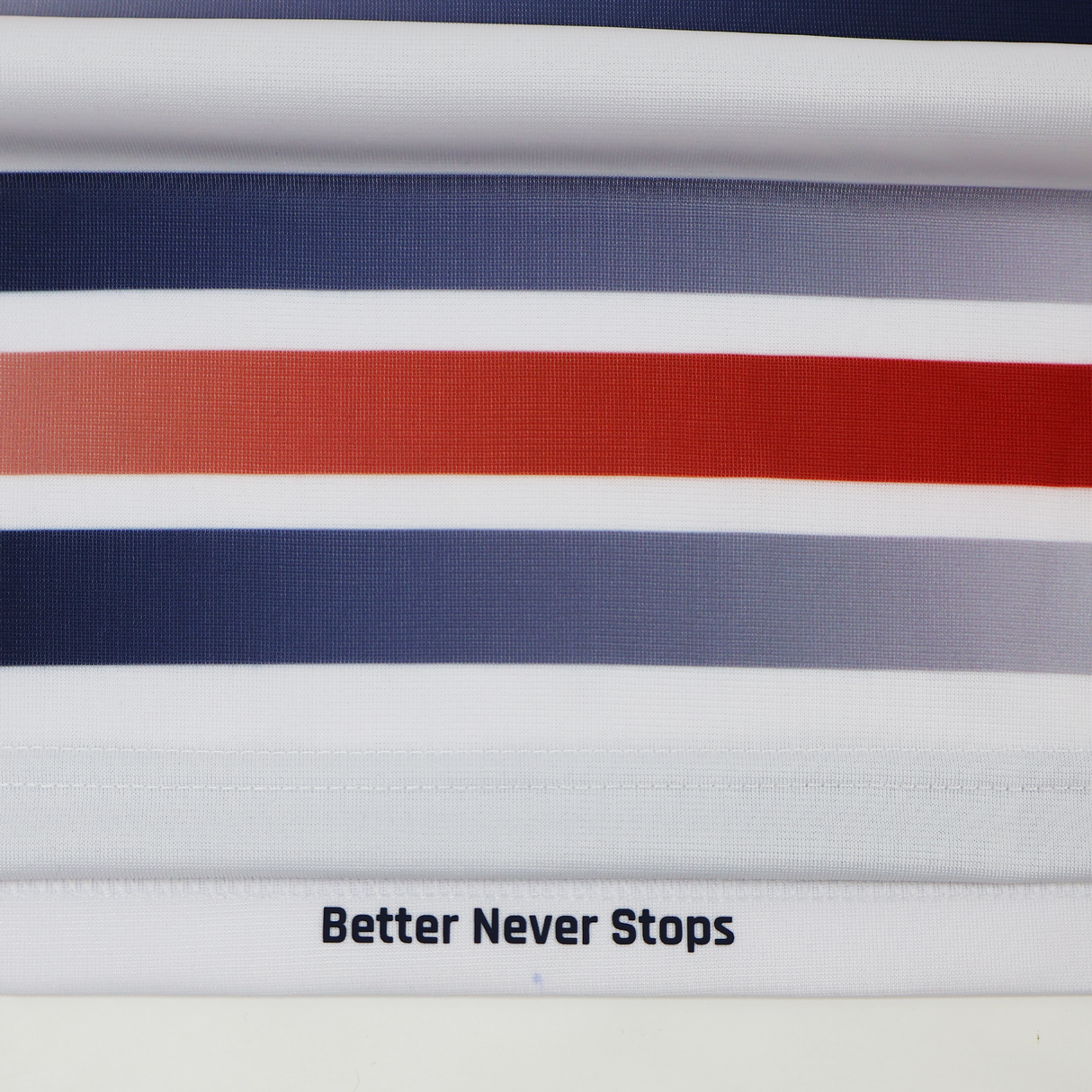 Horizontal stripes in blue, gray, and red with "Better Never Stops" at the hem, inspired by the Castore Women's USA Rugby Replica Home Jersey 22/23.