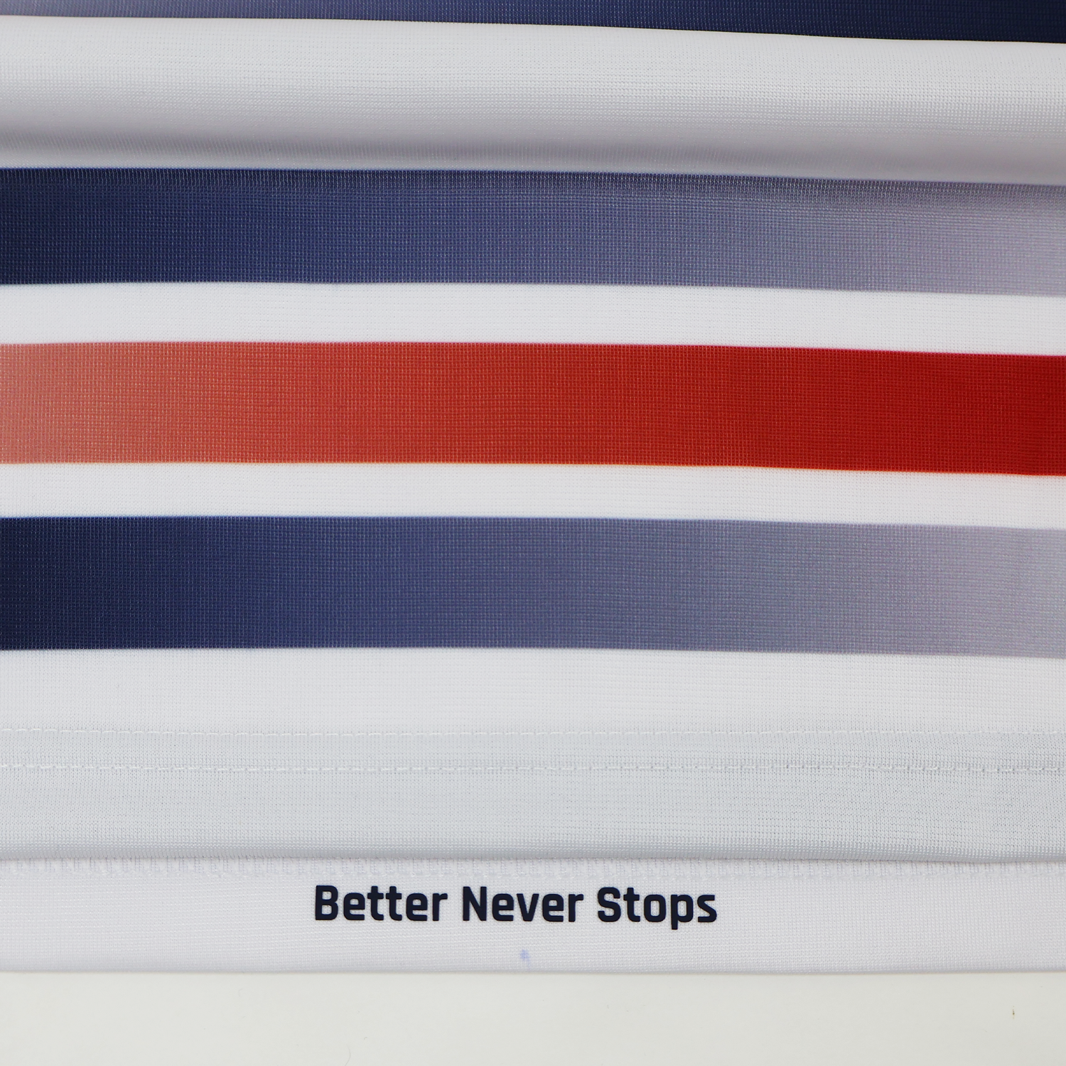Horizontal stripes in blue, gray, and red with "Better Never Stops" at the hem, inspired by the Castore Women's USA Rugby Replica Home Jersey 22/23.