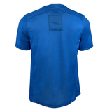 This is the back view of the USA Rugby Training Jersey by Castore, showcasing a plain blue design with a square patch on the upper back, made from premium polyester fabric.