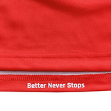 Close-up of a red USA Rugby Training Jersey by Castore with "Better Never Stops" in white near the bottom edge, highlighting its Athletic Fit.