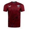 The USA Rugby Printed Training Tee by Castore is maroon with dark sublimated designs, featuring the USA Rugby logo and Castore emblem on the chest.