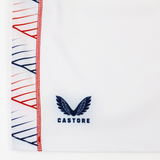 Close-up of USA Rugby 22/23 7's RWC Home Pro Short by Castore, featuring a blue Castore logo with winged emblem and red and blue geometric pattern along the edge.