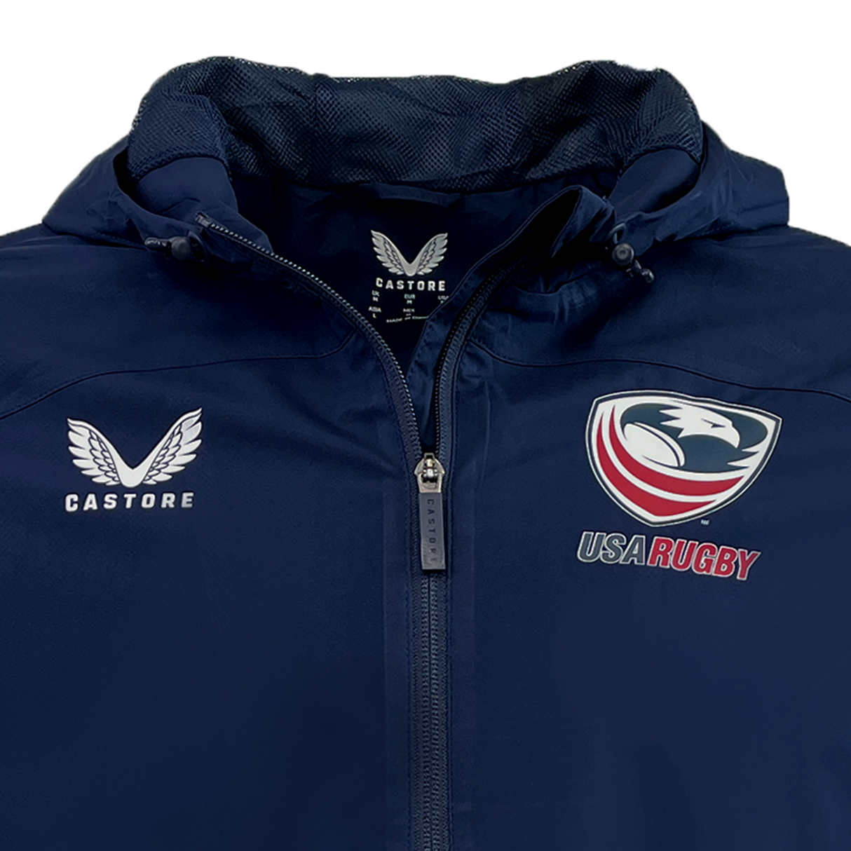 Close-up of the USA Rugby Rain Jacket by Castore in navy blue, showcasing the Castore logo on the left and USA Rugby emblem on the right. This water-resistant jacket includes a zipper, hood, and lightweight mesh lining for comfort and durability.
