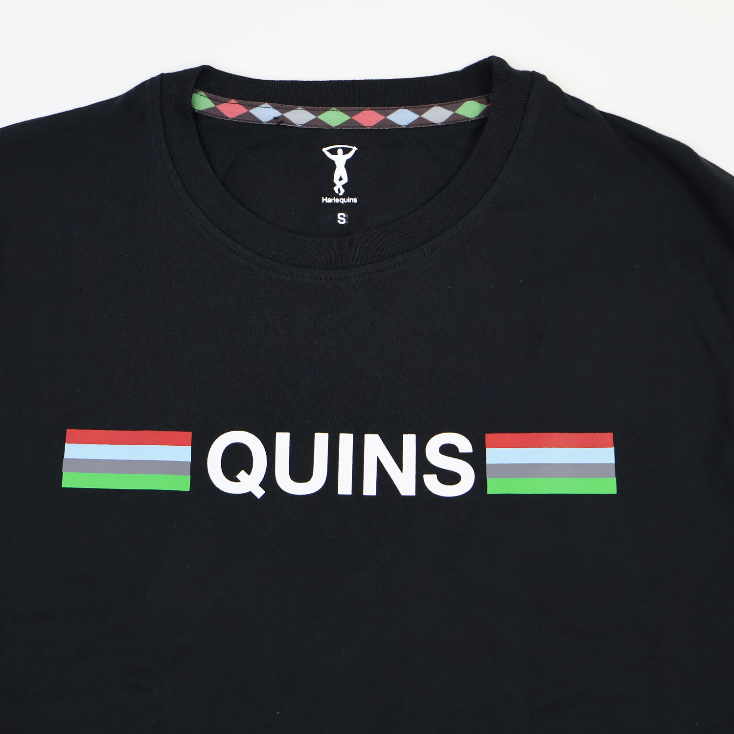 The Harlequins 22/23 Heritage Cotton Tee by Castore features "QUINS" in white between two striped bars in red, white, green, and blue—a classic Harlequins shirt style.
