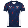 The USA Rugby 23/24 Pro Home Jersey by Castore is a blue men's rugby shirt with red and white accents, featuring the Castore logo, USA Rugby logo, and an American flag patch on the right sleeve—ideal for fans.