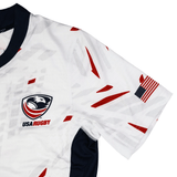 The USA Rugby 23/24 Pro Away Jersey by Castore features red and gray geometric accents, the USA Rugby logo, and an American flag patch on the right sleeve.